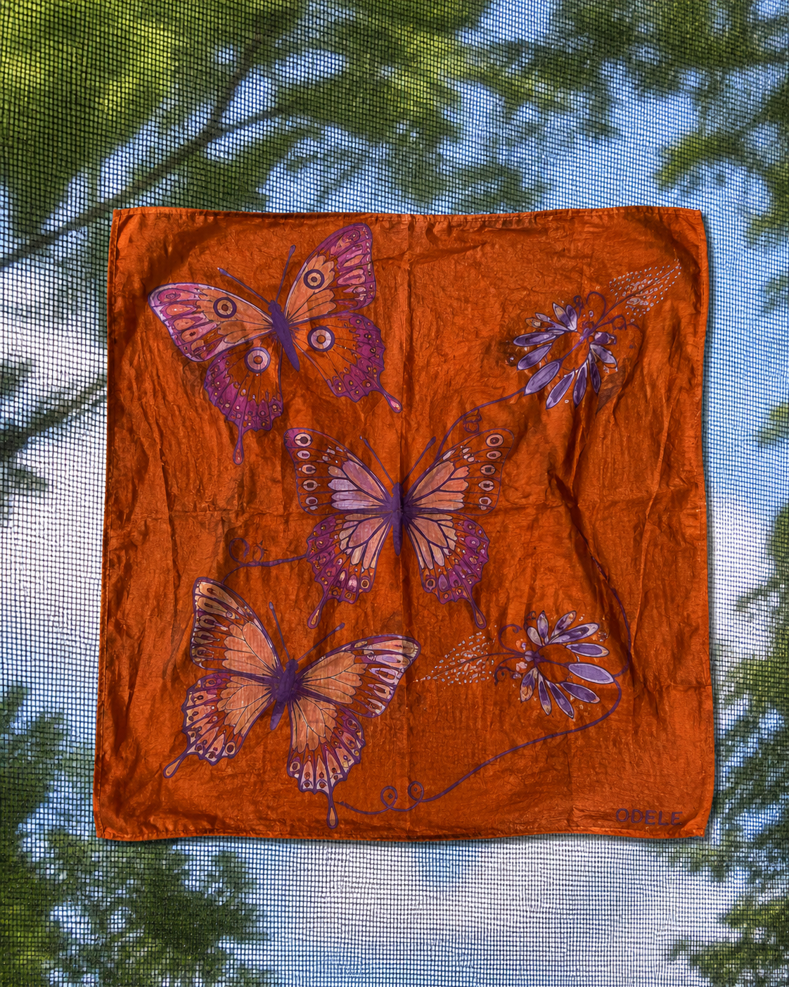 Butterfly Bandana No. 7 displayed against a window and trees