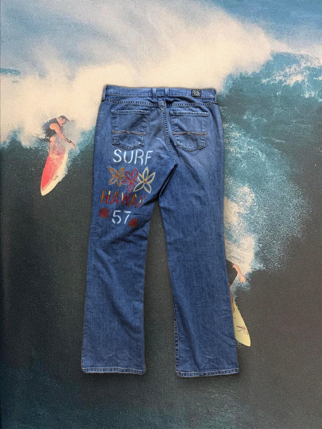 Surf Hawaii '57 hand-painted jeans, styled over a vintage big-wave surf photo