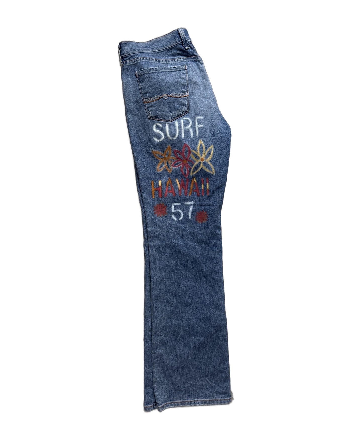 Side view of the Surf Hawaii '57 hand-painted Lucky Brand jeans on white