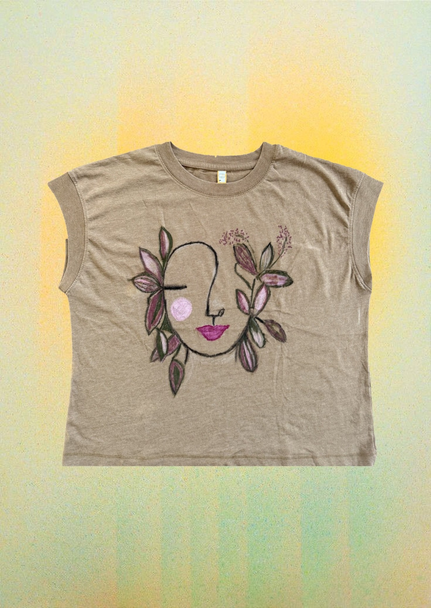 Floral Face Relaxed Tee styled over a soft yellow gradient