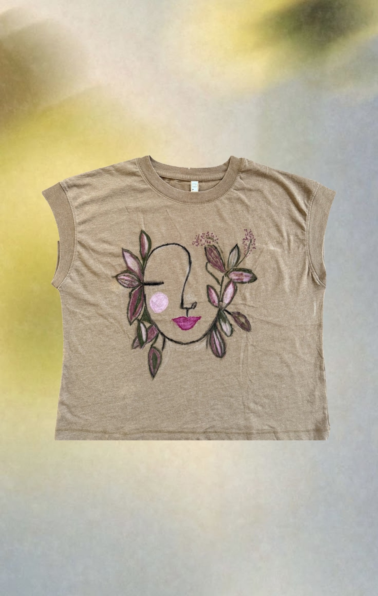 Floral Face Relaxed Tee styled over soft blue and yellow blurred light