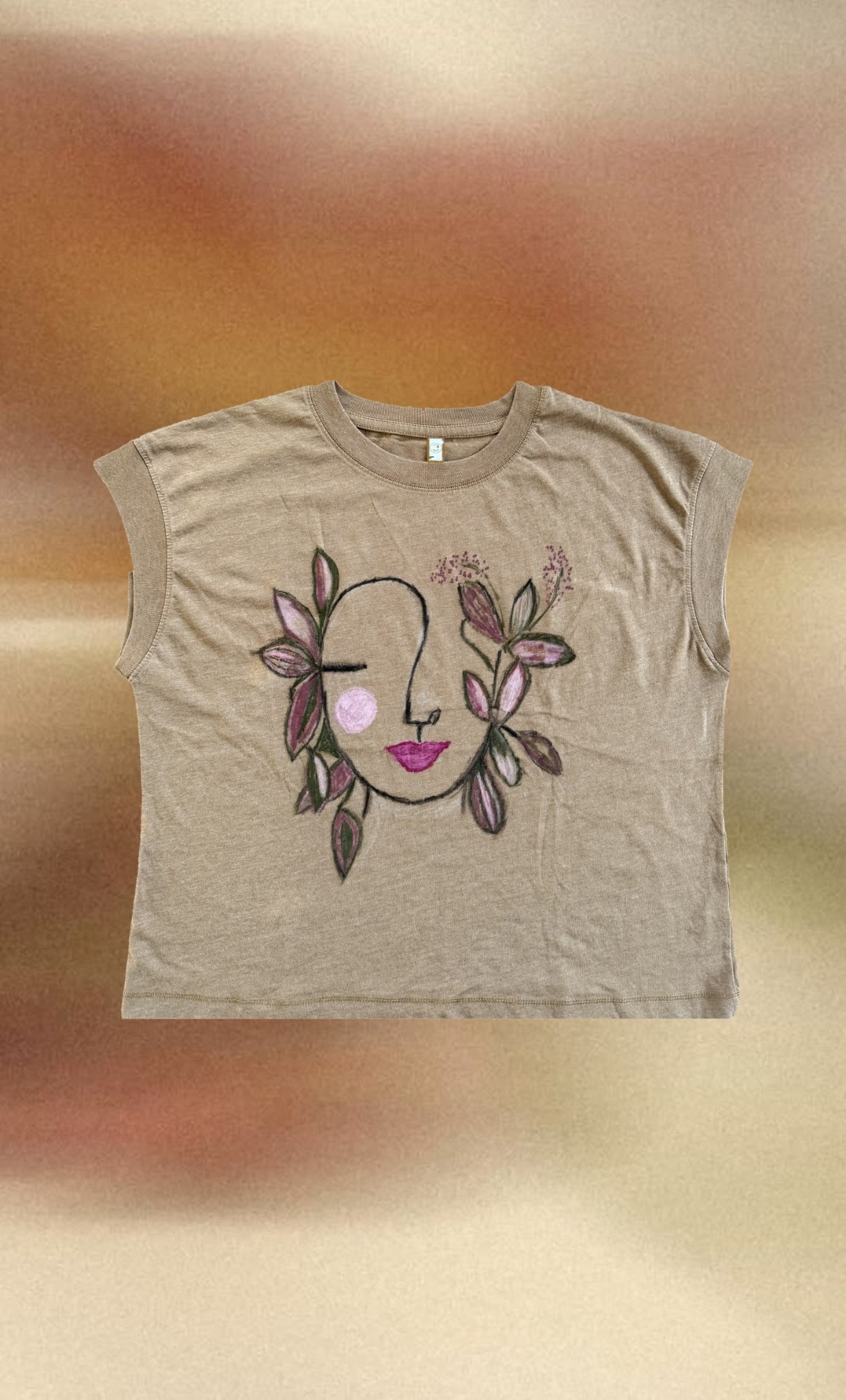 Floral Face Relaxed Tee styled over warm blurred tones