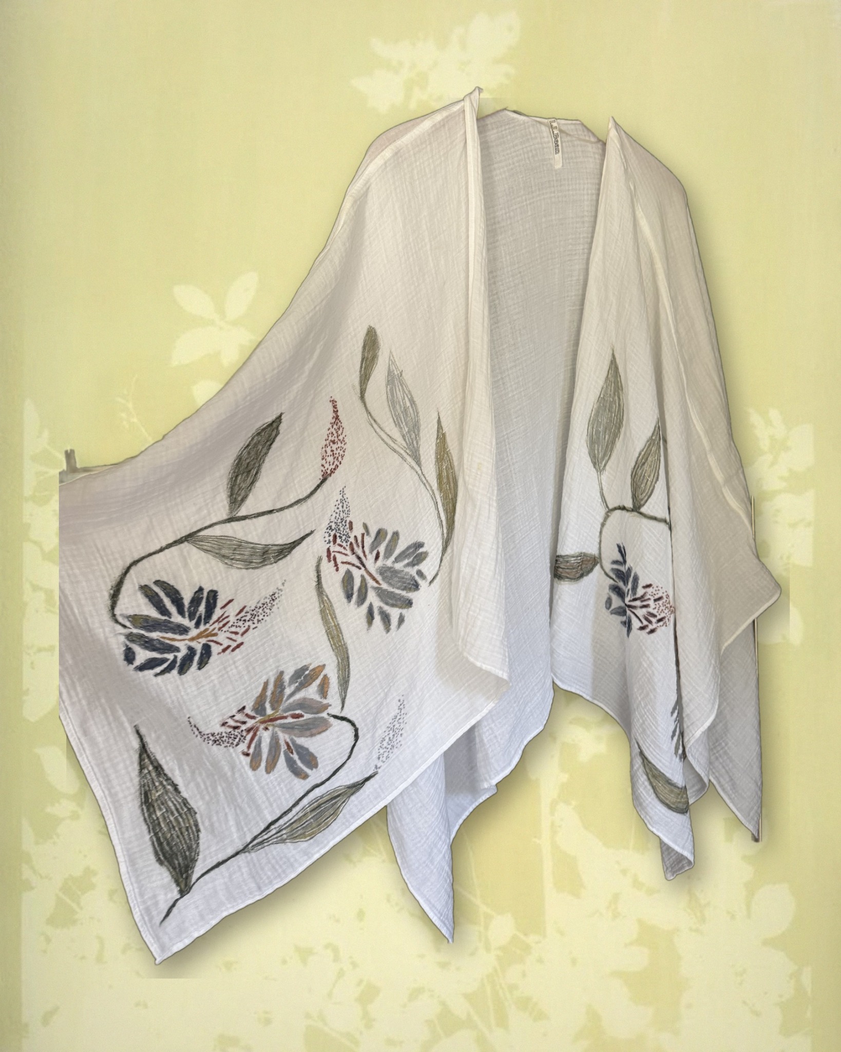 Hand-painted floral shawl draped, styled over a vintage botanical print
